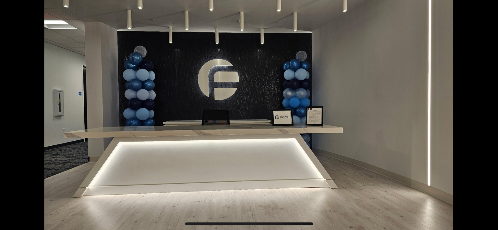 Modern commercial reception desk with feature wall