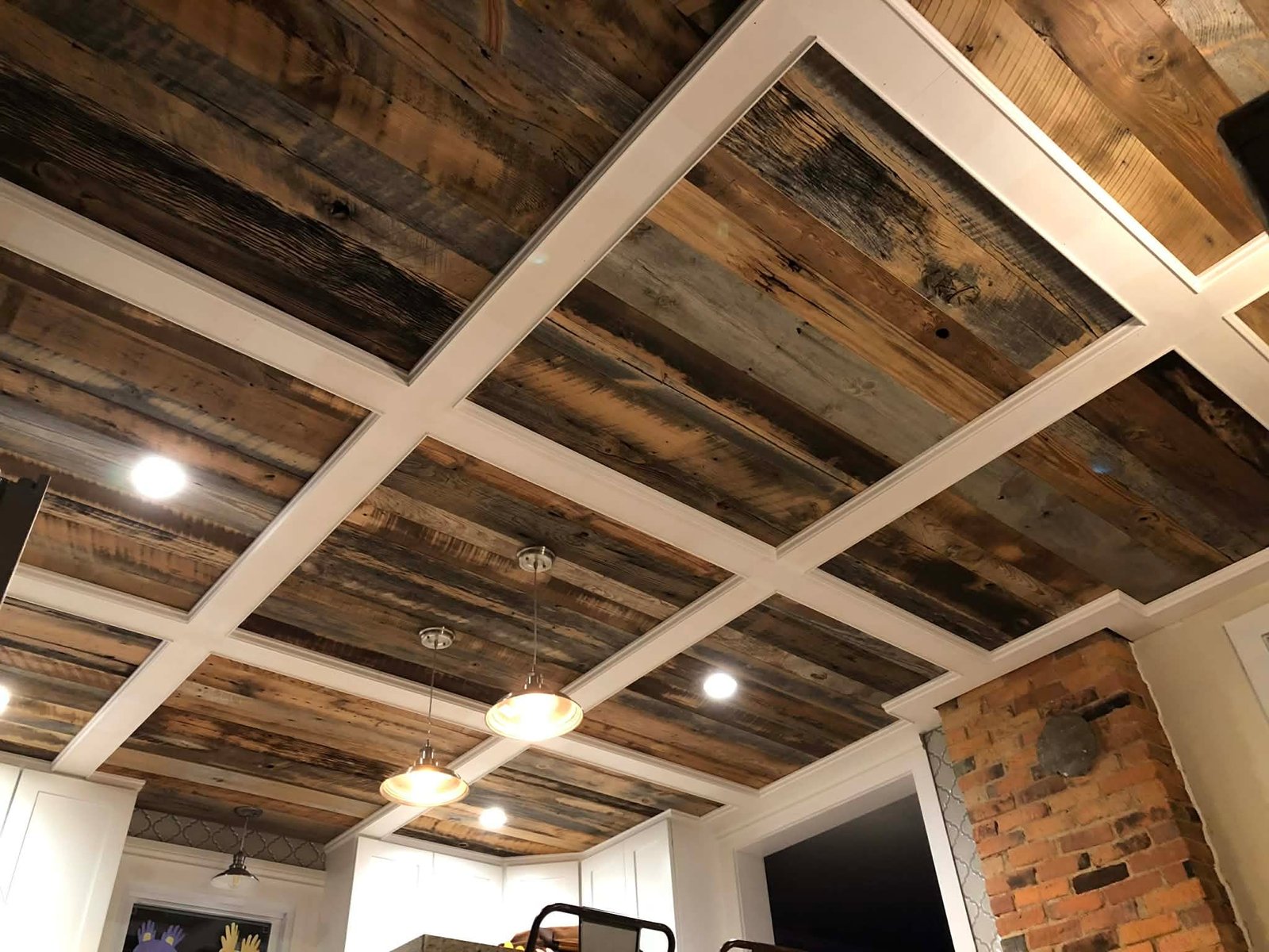 Close-up detail of reclaimed wood insets inside a coffered ceiling grid